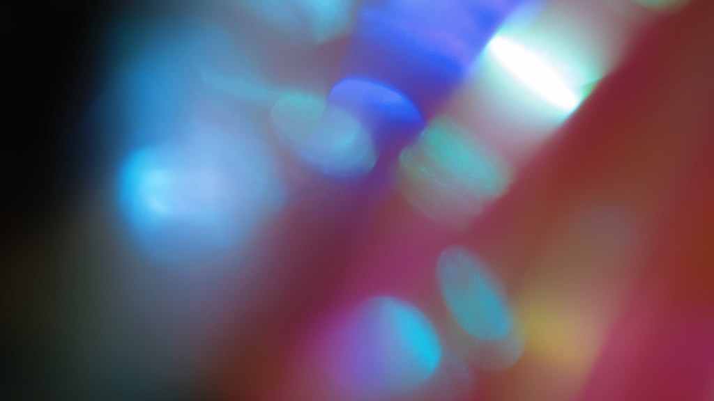 Colorful abstract image with a gradient of blue and pink blurred light spots creating a surreal effect.