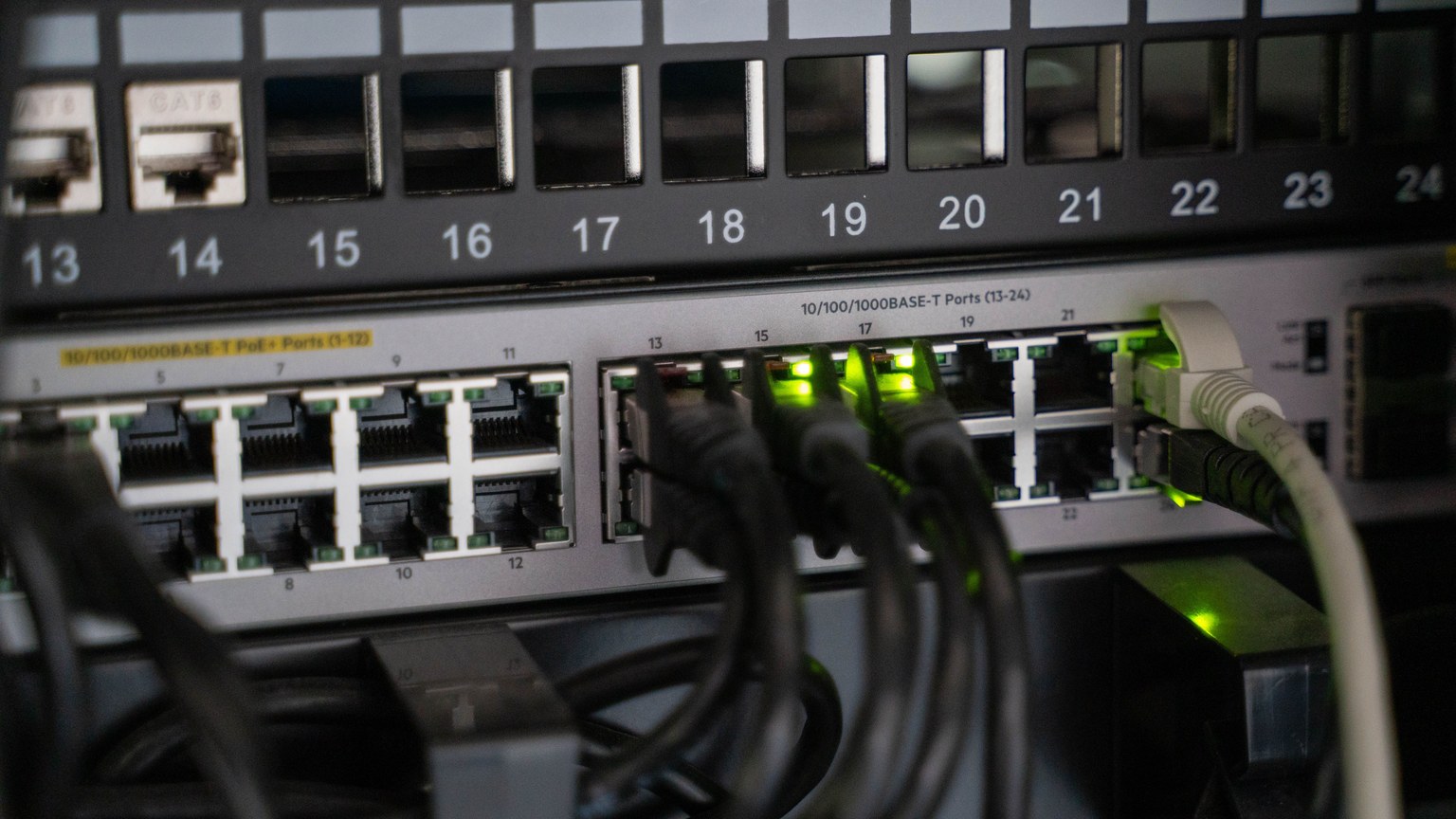 Networking equipment with connected cables, showcasing modern technology infrastructure.