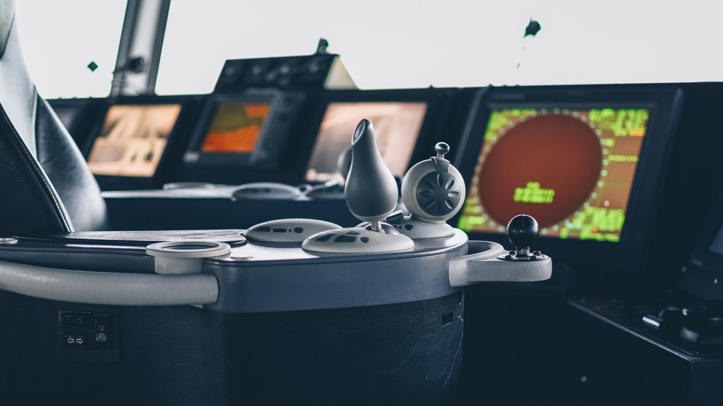 Close-up view of ship navigation controls and radar screens, capturing maritime technology.