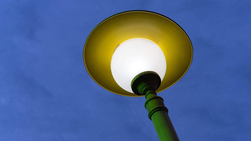 Bright street lamp in Baku, Azerbaijan, glowing warmly against the evening sky.
