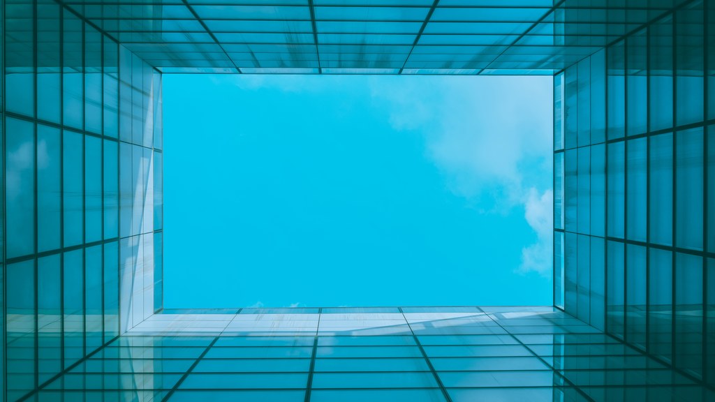 A stunning view of the blue sky through a modern architectural skylight with geometric patterns.