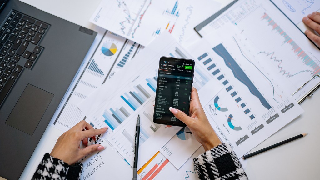 A top view on charts and smartphone in an office, showcasing data analytics.