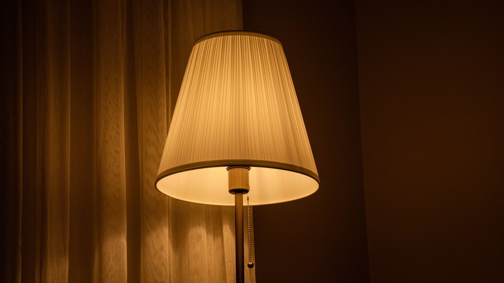 Softly glowing table lamp in a cozy room creates a warm and inviting atmosphere.