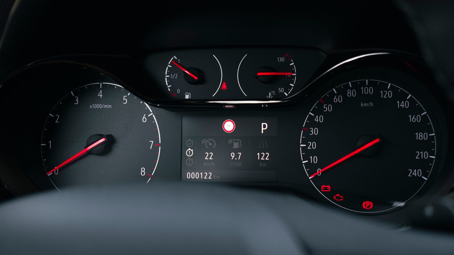 Detailed view of a modern car dashboard with speedometer and fuel gauge indicators.