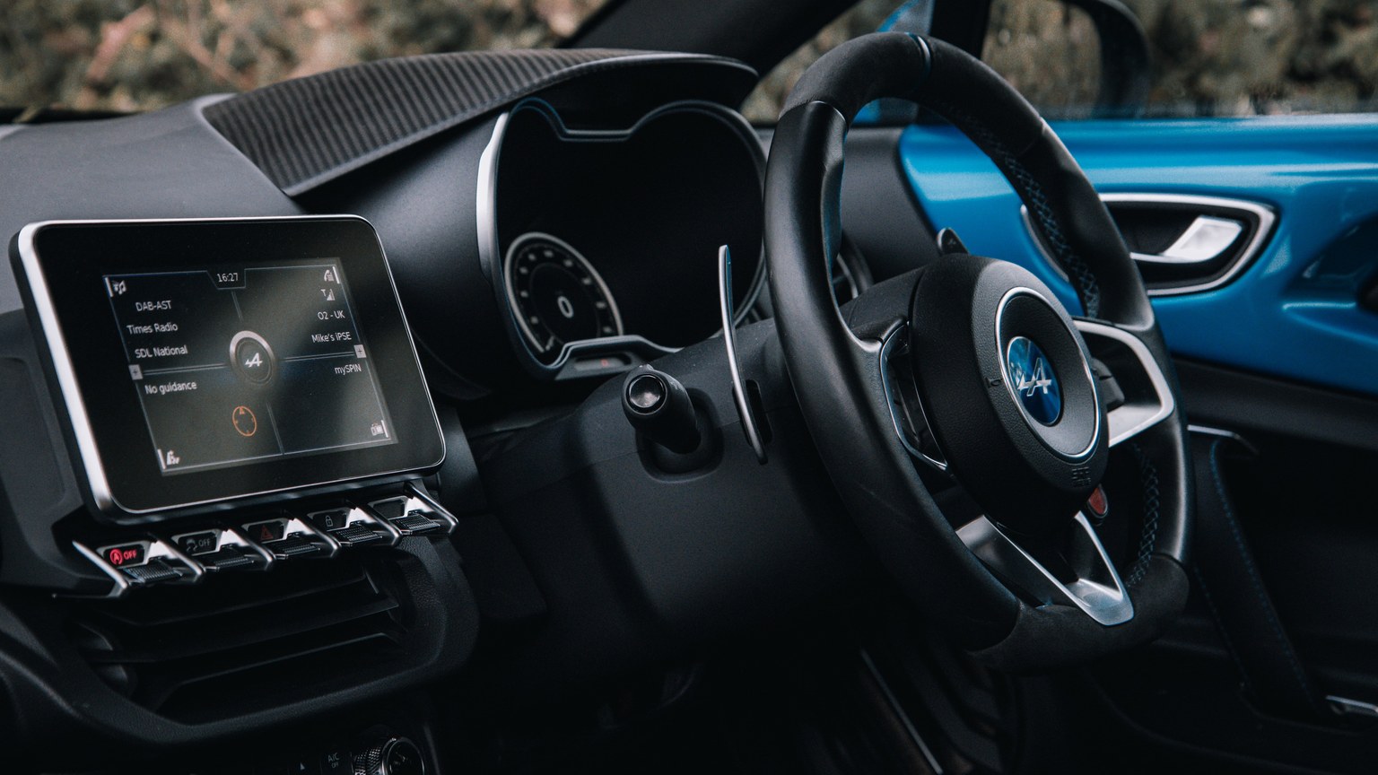 Close-up of a sleek car interior showcasing the dashboard and steering wheel.