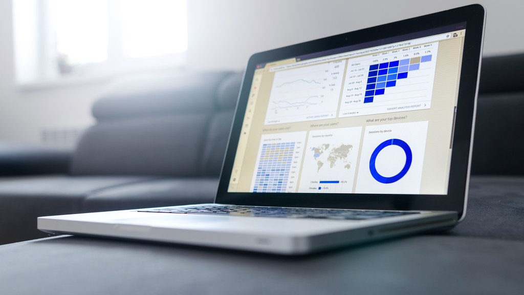 Sleek laptop showcasing data analytics and graphs on the screen in a bright room.