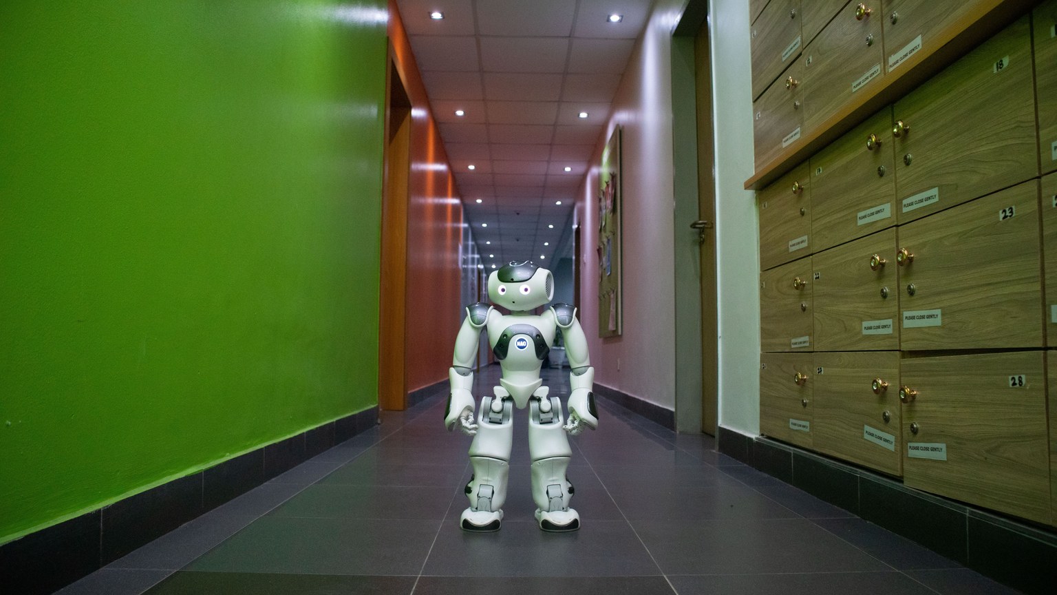 A humanoid robot stands in a vibrant, modern hallway in Lagos, Nigeria.