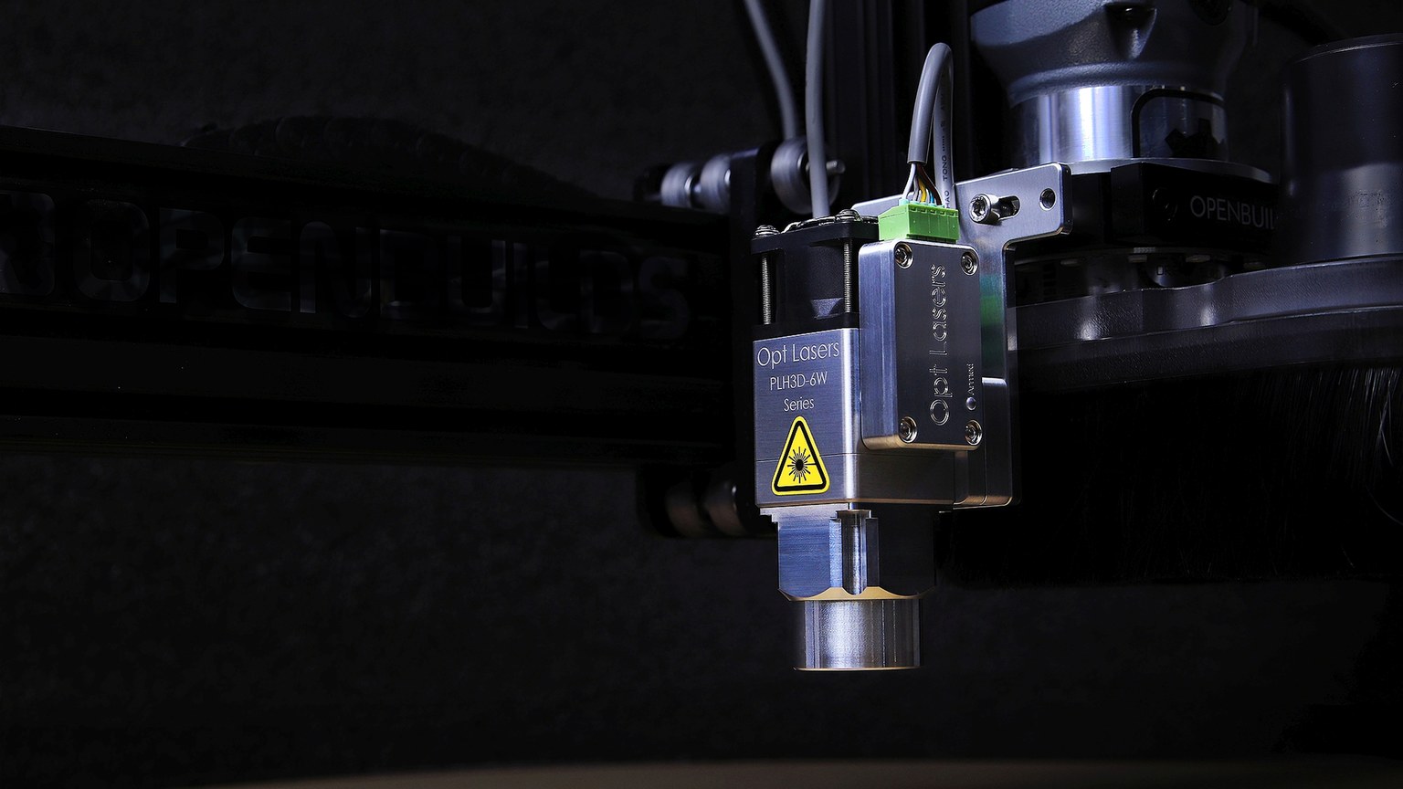 Detailed view of an Opt Lasers engraving machine in operation, showcasing precision technology.