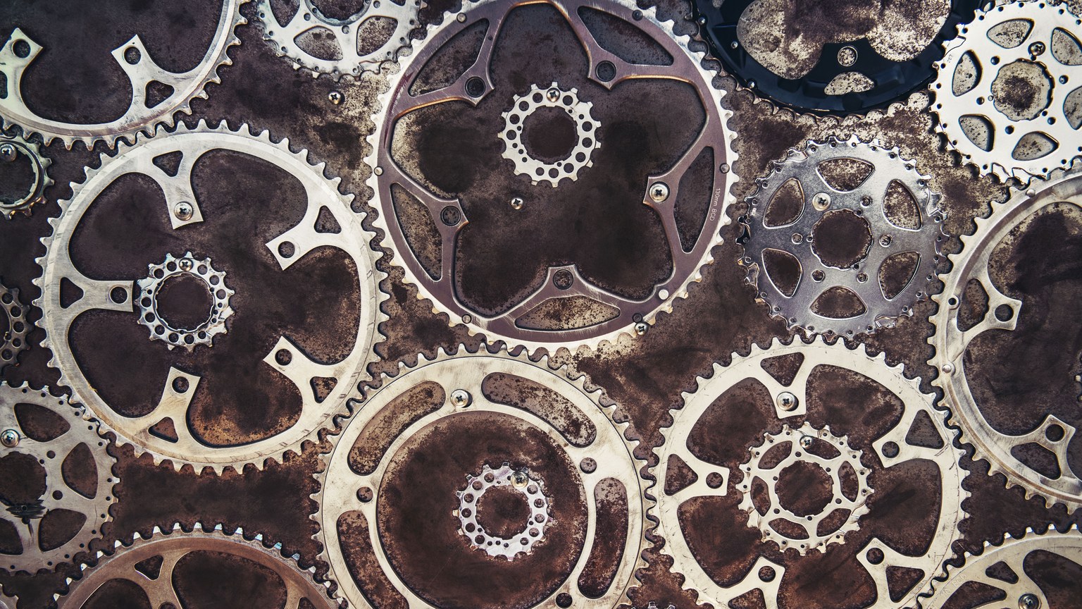Close-up of interlocking metal gears creating an industrial texture.
