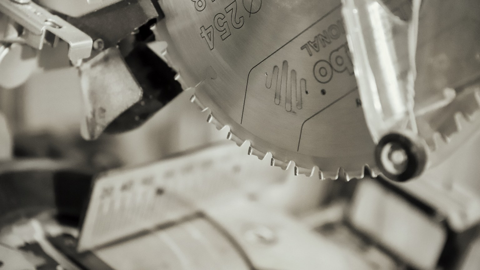 Detailed view of a circular saw blade in an industrial workshop, showcasing precision and craftsmanship.