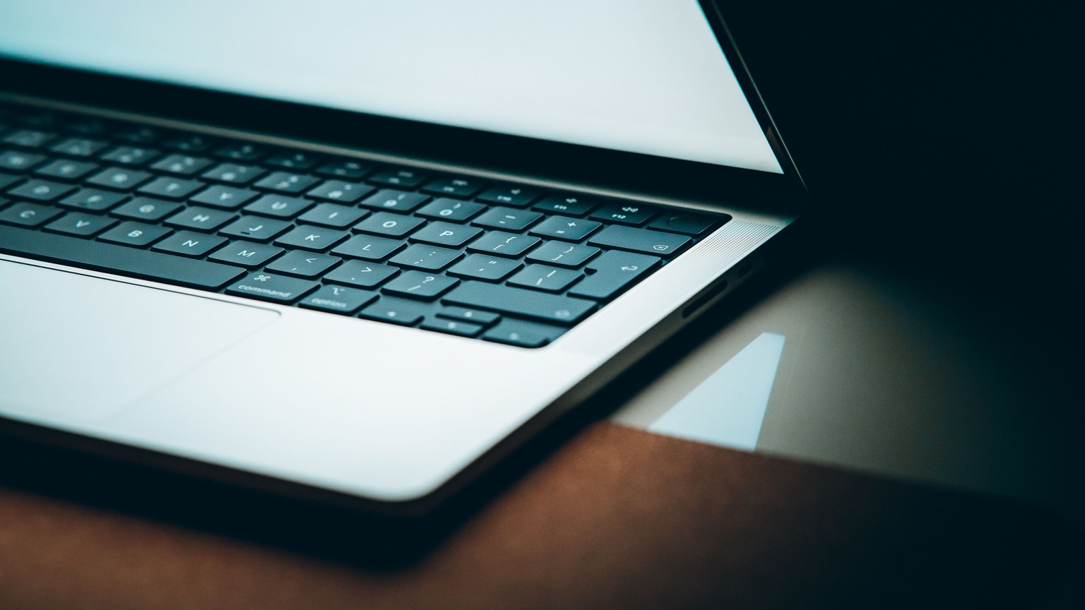 Close-up of a modern laptop keyboard with a backlit display, emphasizing sleek design.