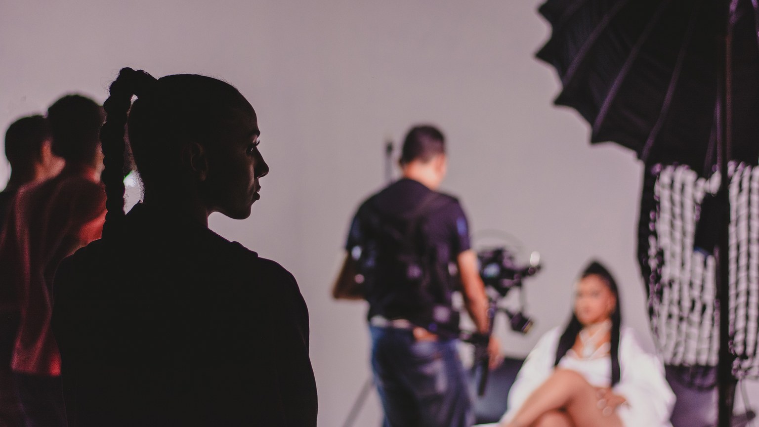 Capturing the essence of a fashion photo shoot with models and photographers in a studio.