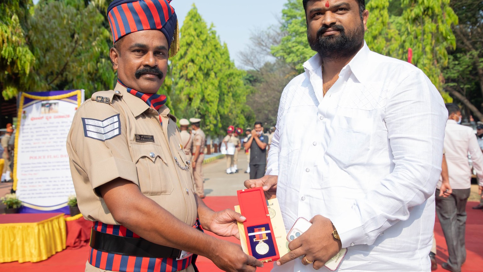 Police officer awarded honorary medal at outdoor ceremony