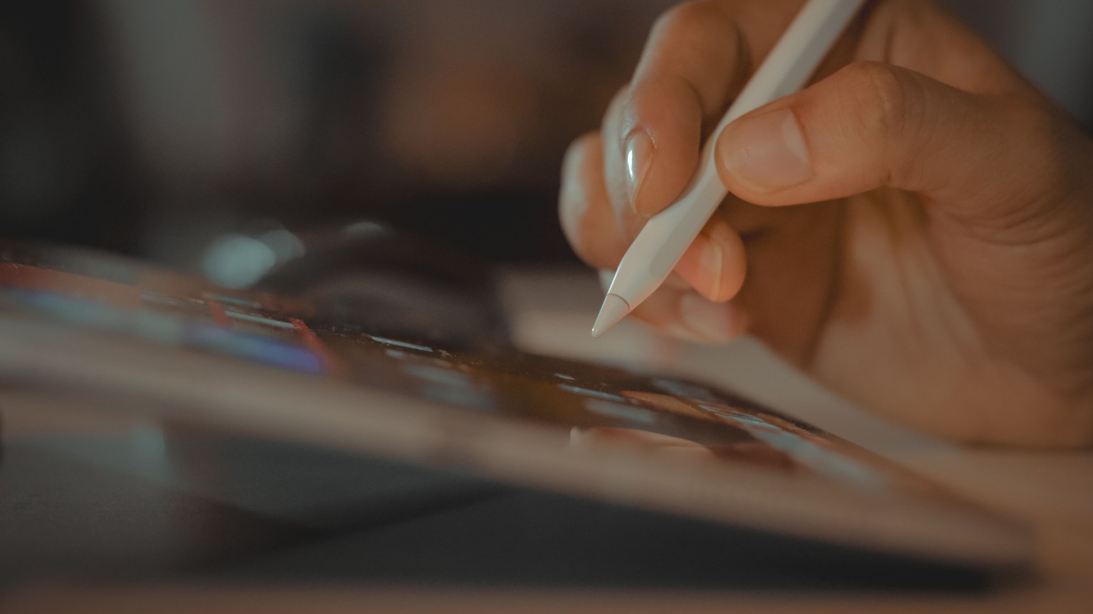 A close-up of a hand using a stylus on a tablet, showcasing digital interaction in Dubai.