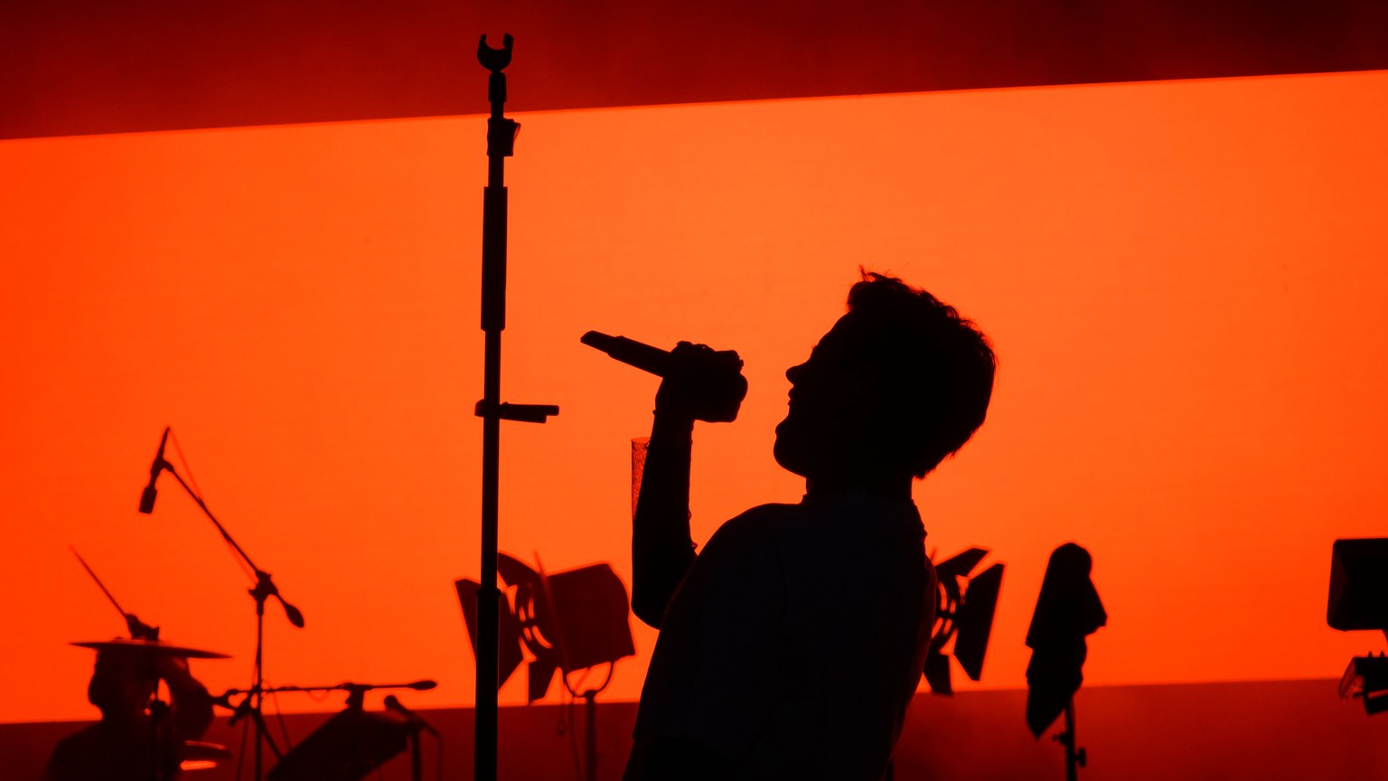 Dramatic silhouette of a singer performing on stage during a live evening concert in Ankara.