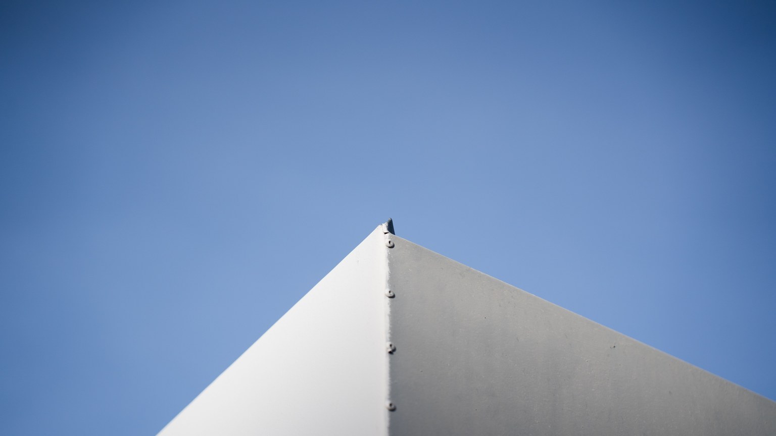 A minimalist architectural corner against a vivid blue sky showcasing simplicity and modern design.