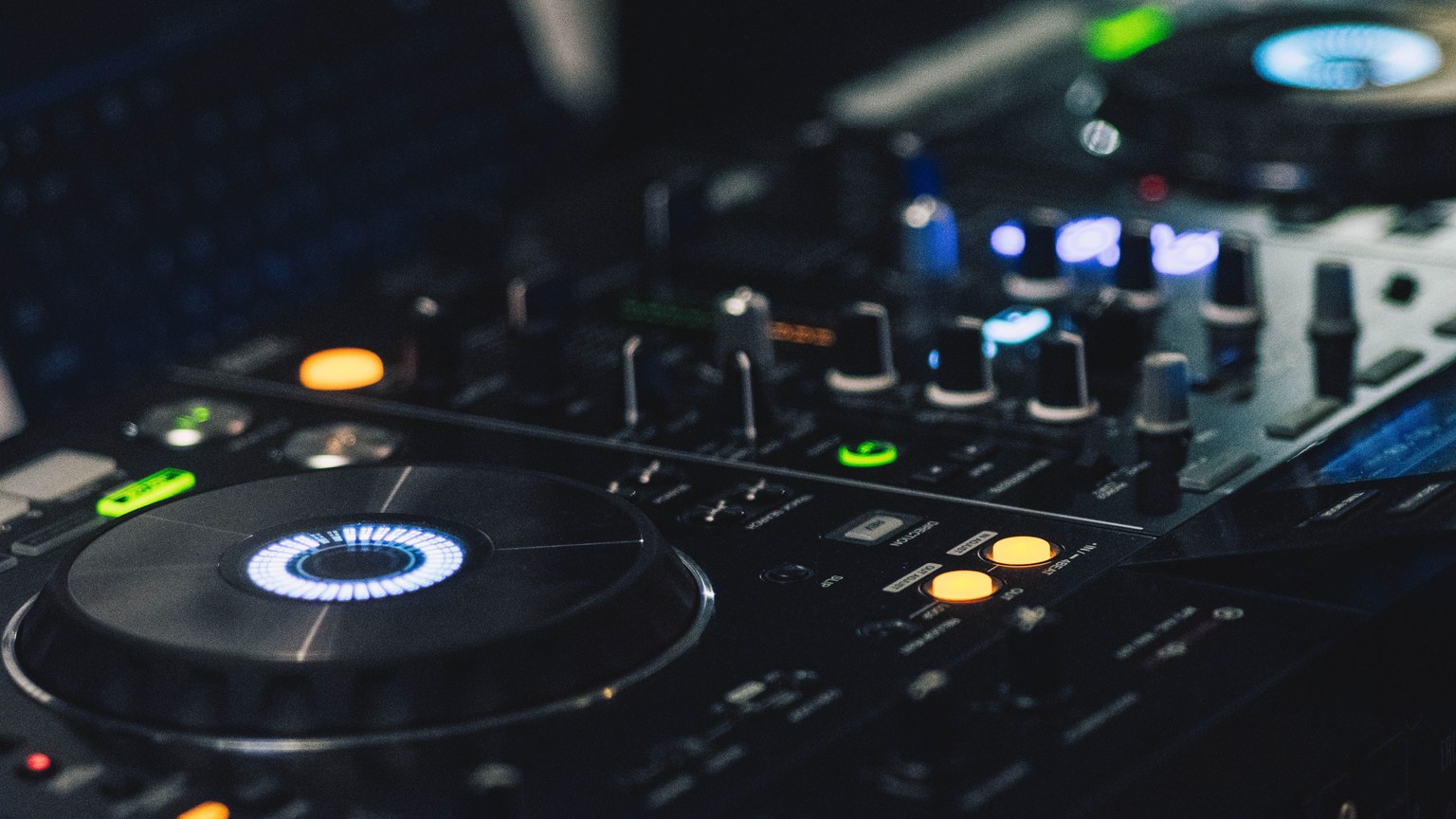 A detailed shot of professional DJ equipment featuring knobs and LED lights, perfect for music events.