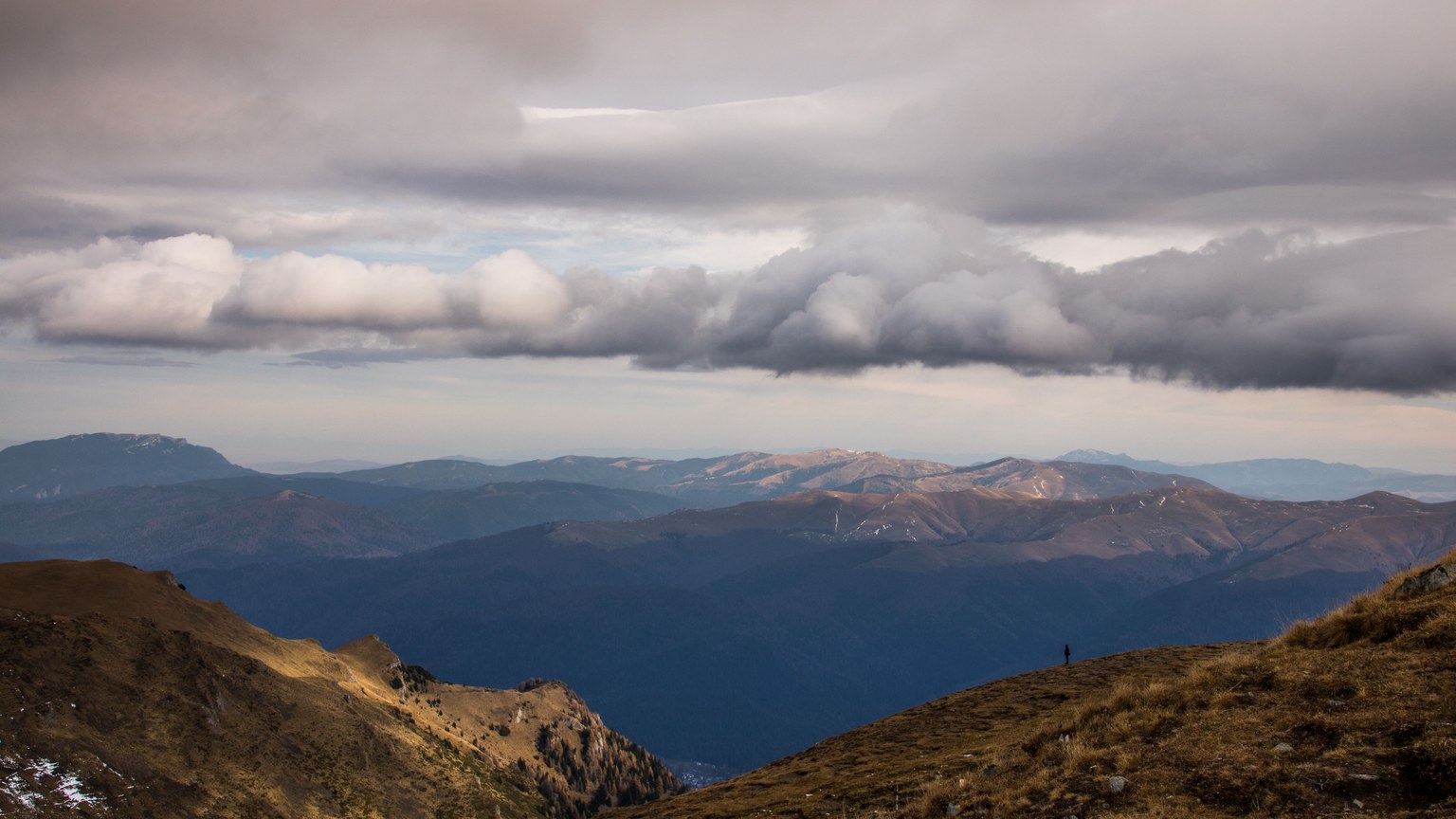 A breathtaking mountain landscape under dramatic cloud cover, ideal for nature photography.