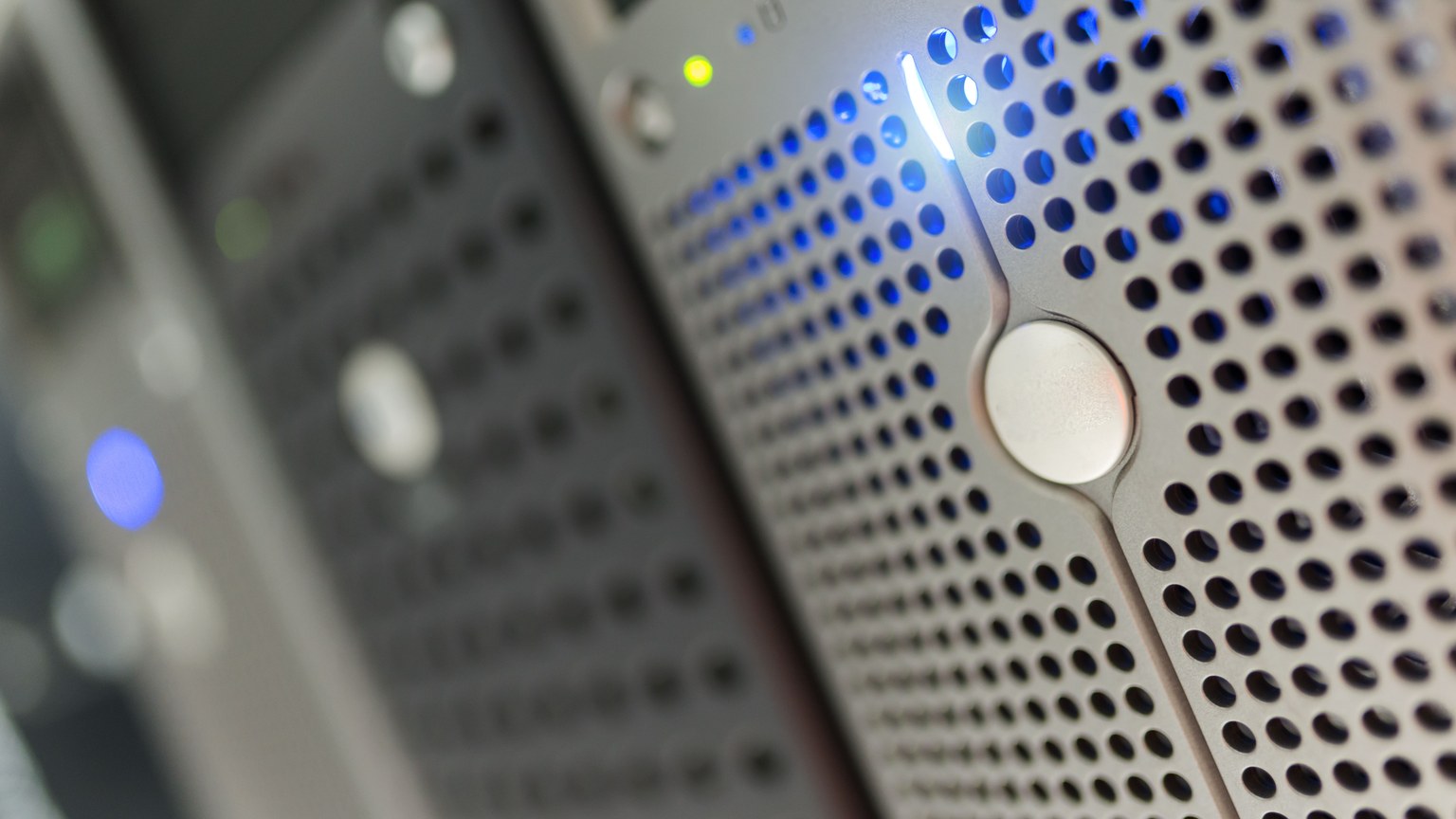 Focused detail of a modern server rack with blue LED indicators in a data center.
