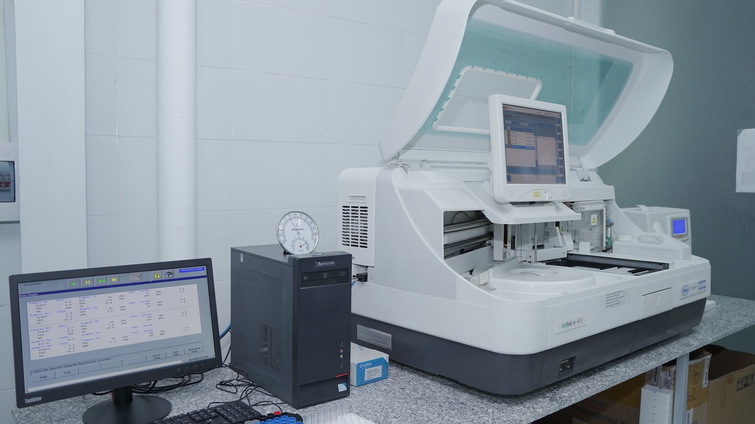 High-tech laboratory equipment with computer system in lab setting.