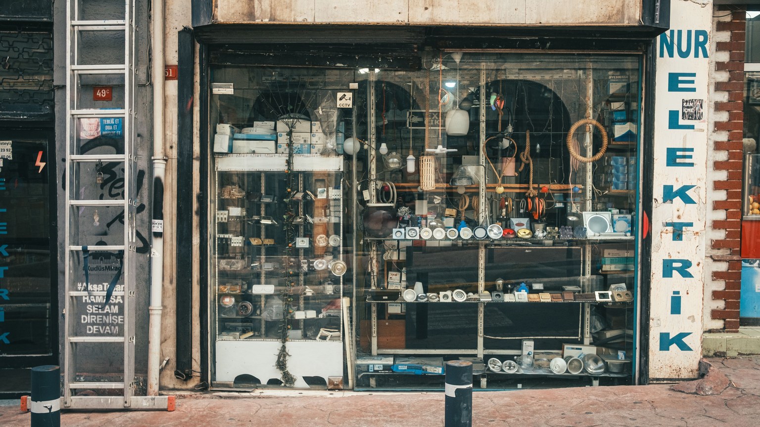 Showcase of a vintage electrical store with assorted gadgets in a rustic setting.