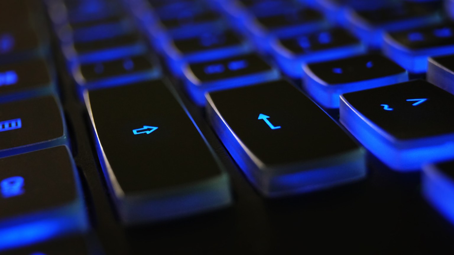 Detailed image of a computer keyboard with blue LED backlighting, highlighting keys.