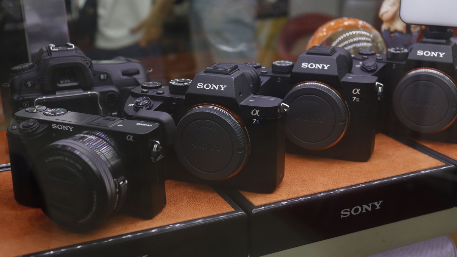 A collection of Sony digital cameras showcased in a store display case.