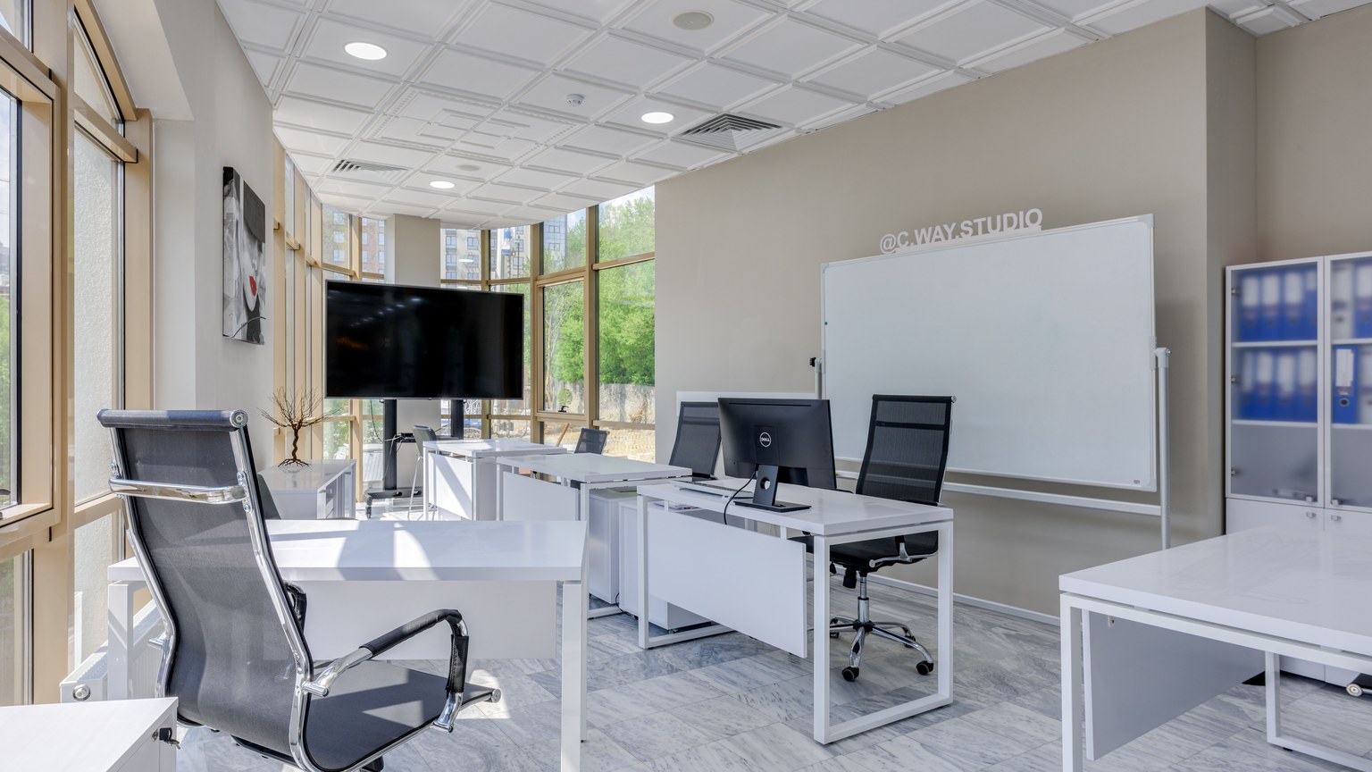 Spacious and bright modern office interior with sleek furniture, ideal for professional workspaces.