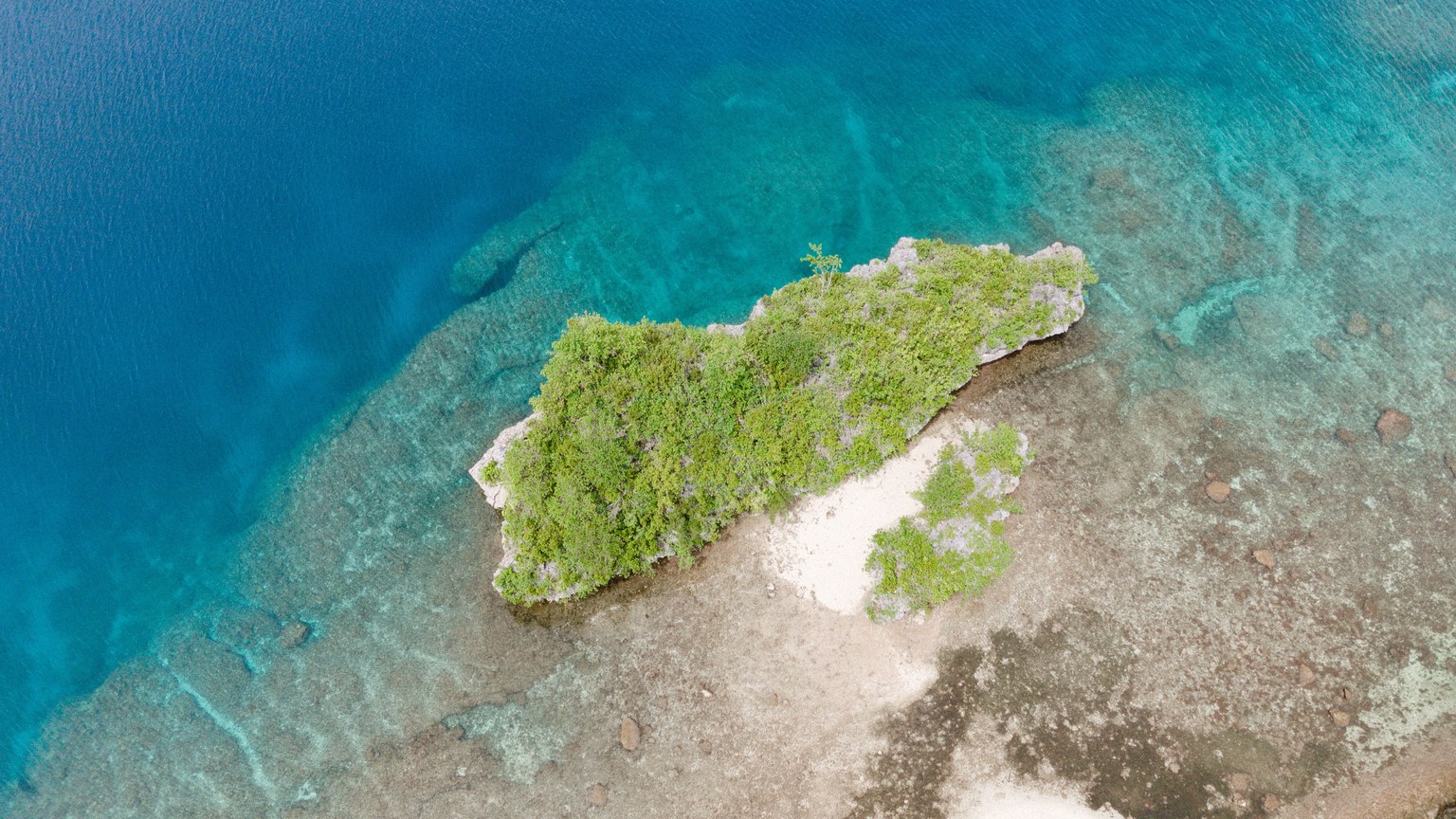 Stunning aerial photo of Liloan's pristine island coastline with lush greenery.