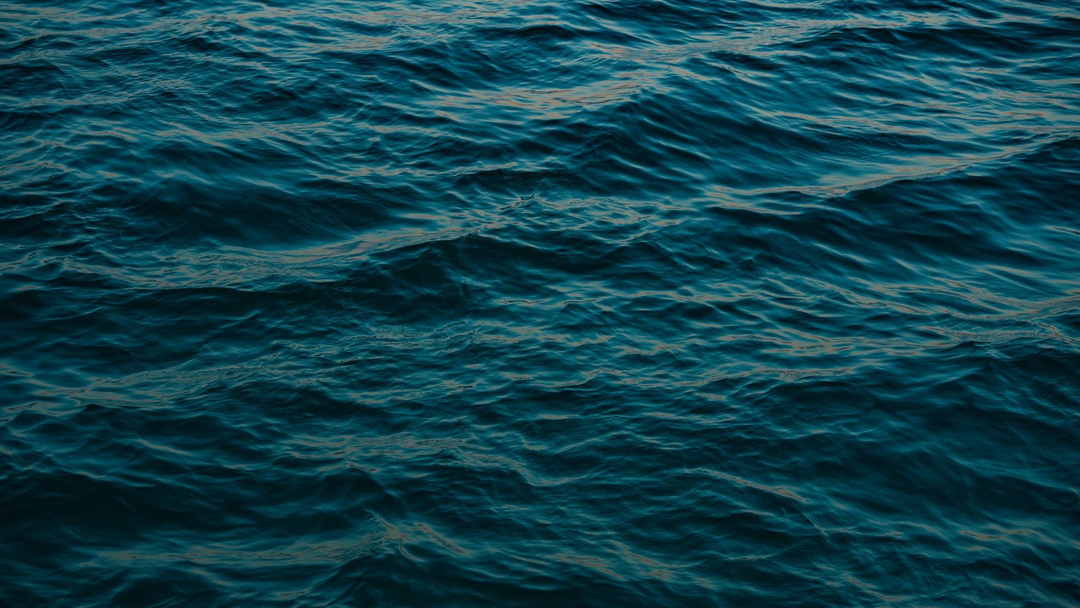 A peaceful view of ocean waves with rich blue hues, capturing the sea's tranquility.
