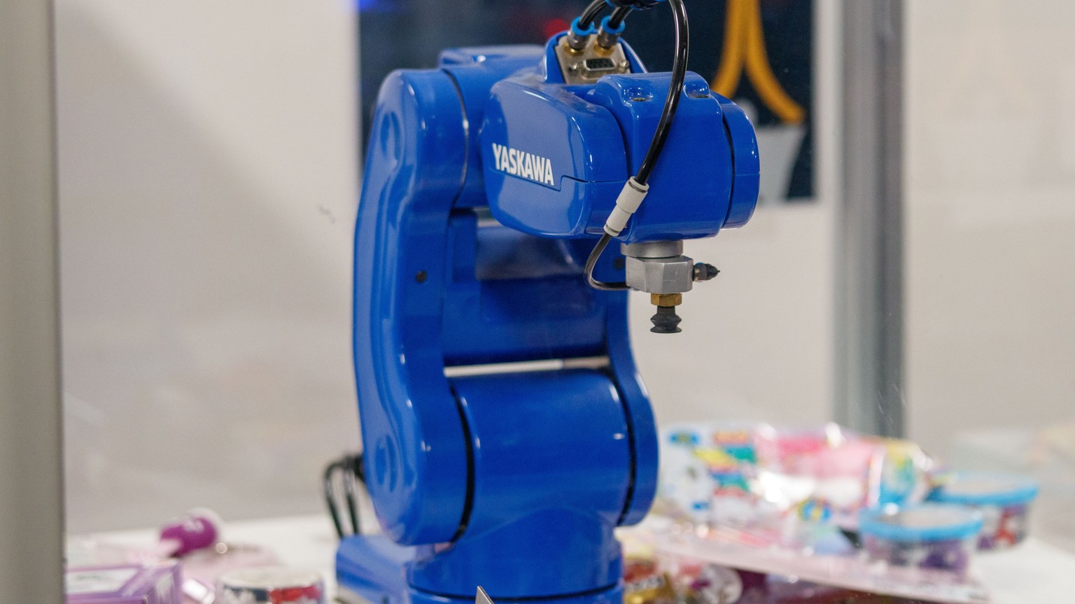 A blue Yaskawa industrial robot arm on display, showcasing advanced technology and robotics.