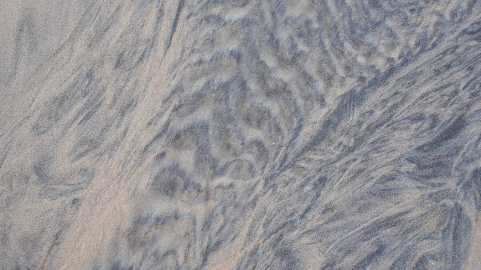 Intricate patterns formed by nature in sand, showcasing abstract textures and organic lines.