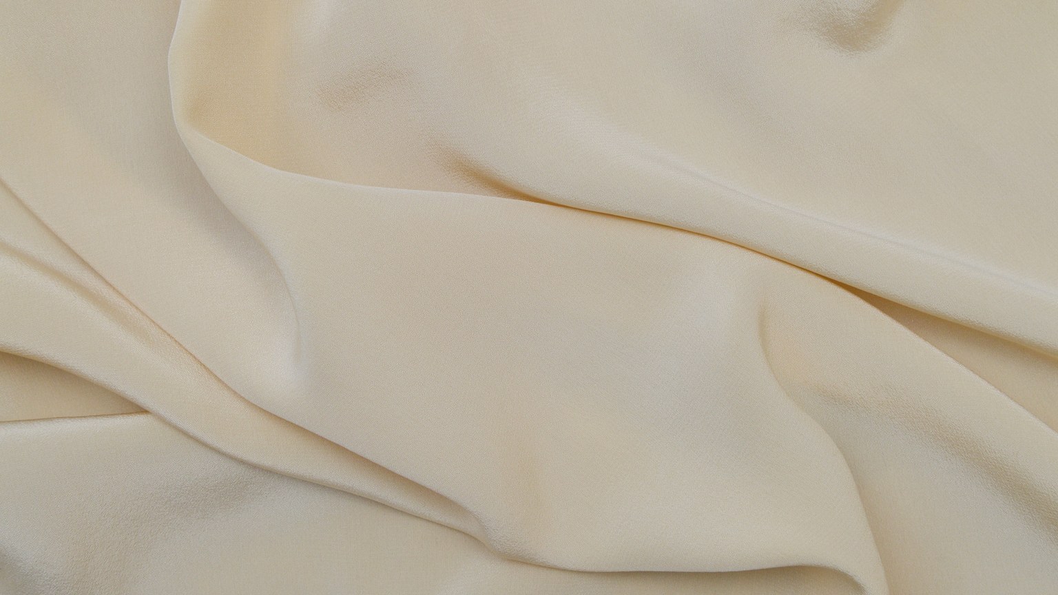 Detailed close-up image of beige fabric with soft, wavy texture.