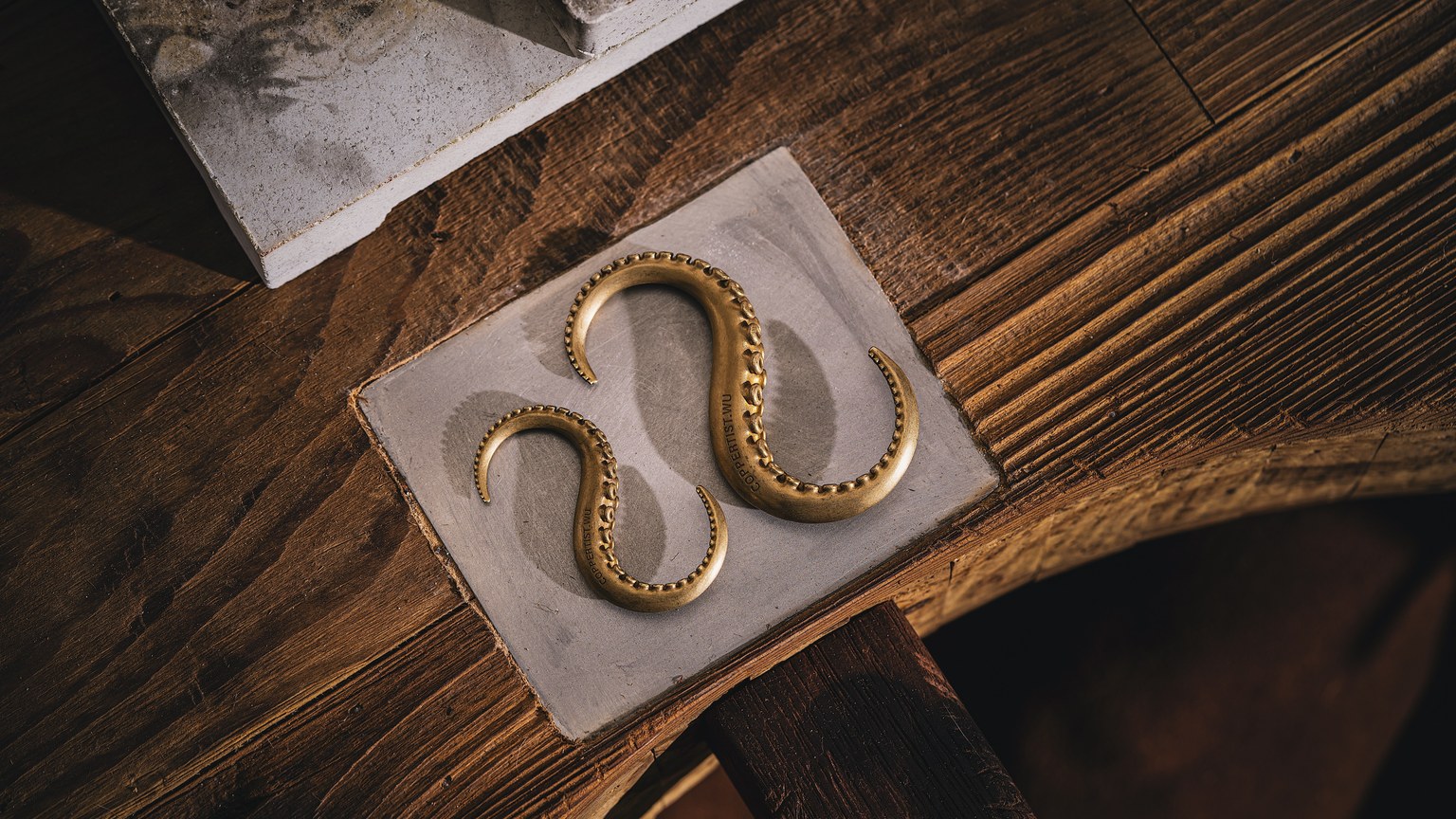 A vintage wooden desk with a gold octopus-like ornament, evoking antique charm.