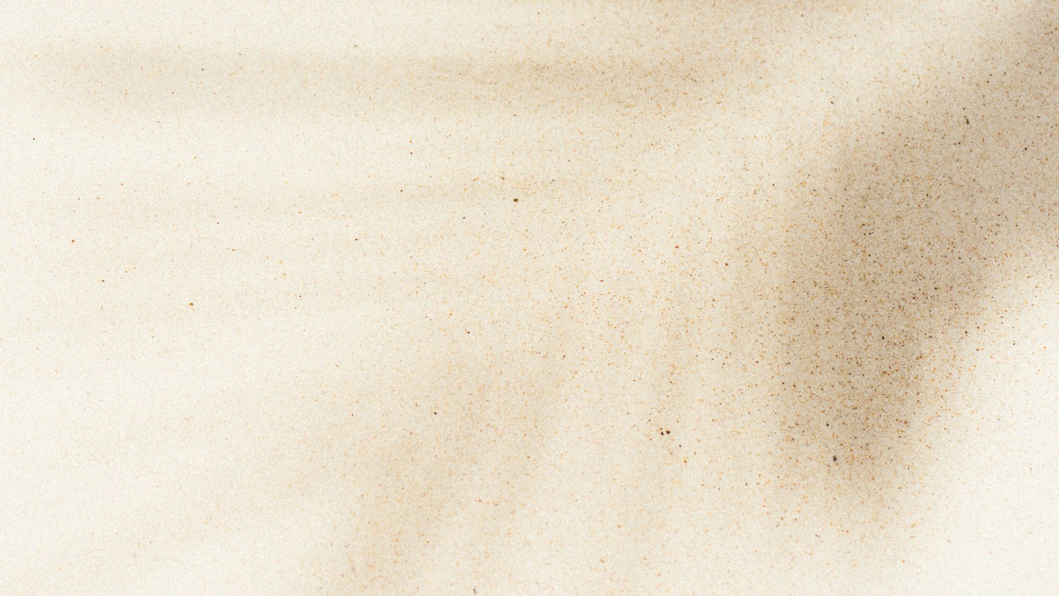 Artistic sand texture with natural shadows creating a serene abstract pattern, perfect for background use.
