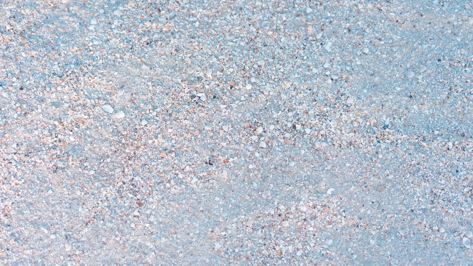 Detailed texture of pebbles and sand, perfect for backgrounds and design projects.