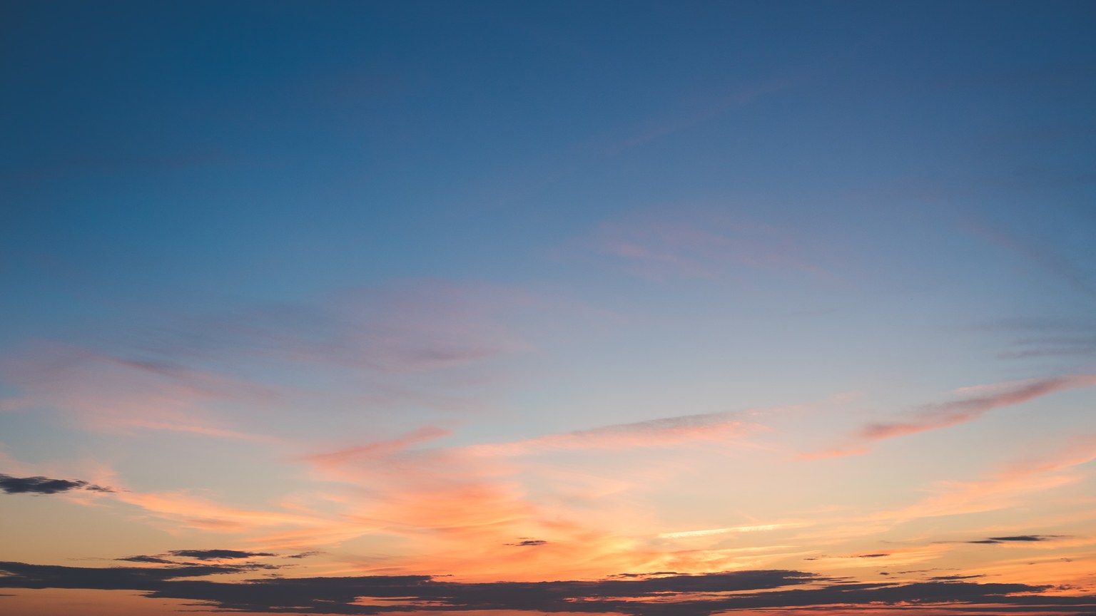A beautiful sunset with vibrant colors over a tranquil body of water.