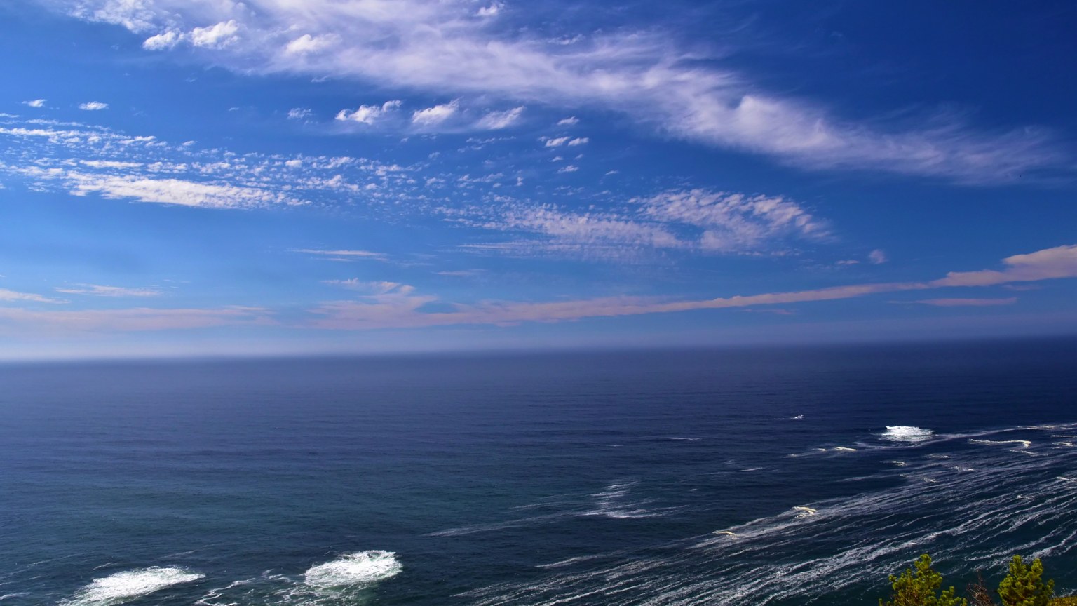 Breathtaking view of the ocean under a bright blue sky, ideal for serene stock imagery.