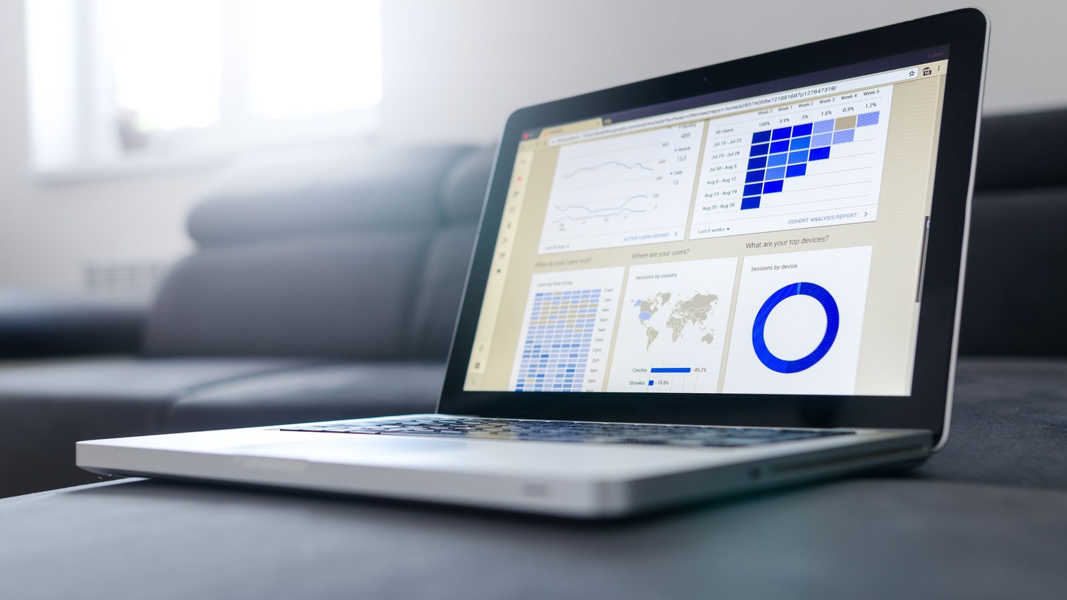 Sleek laptop showcasing data analytics and graphs on the screen in a bright room.