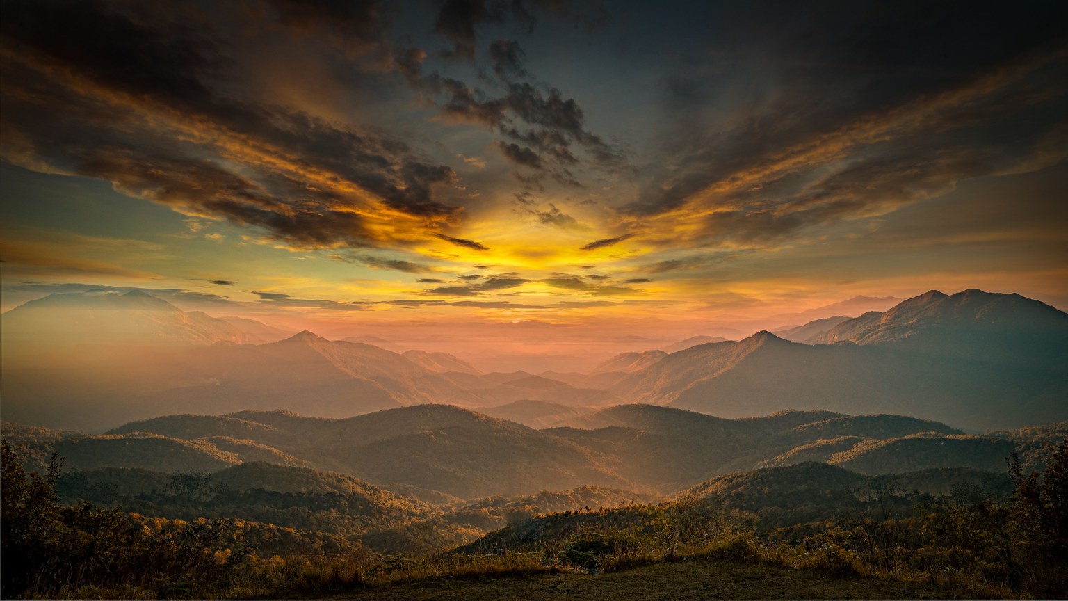 Stunning sunrise over a serene mountain landscape showcasing nature's beauty.