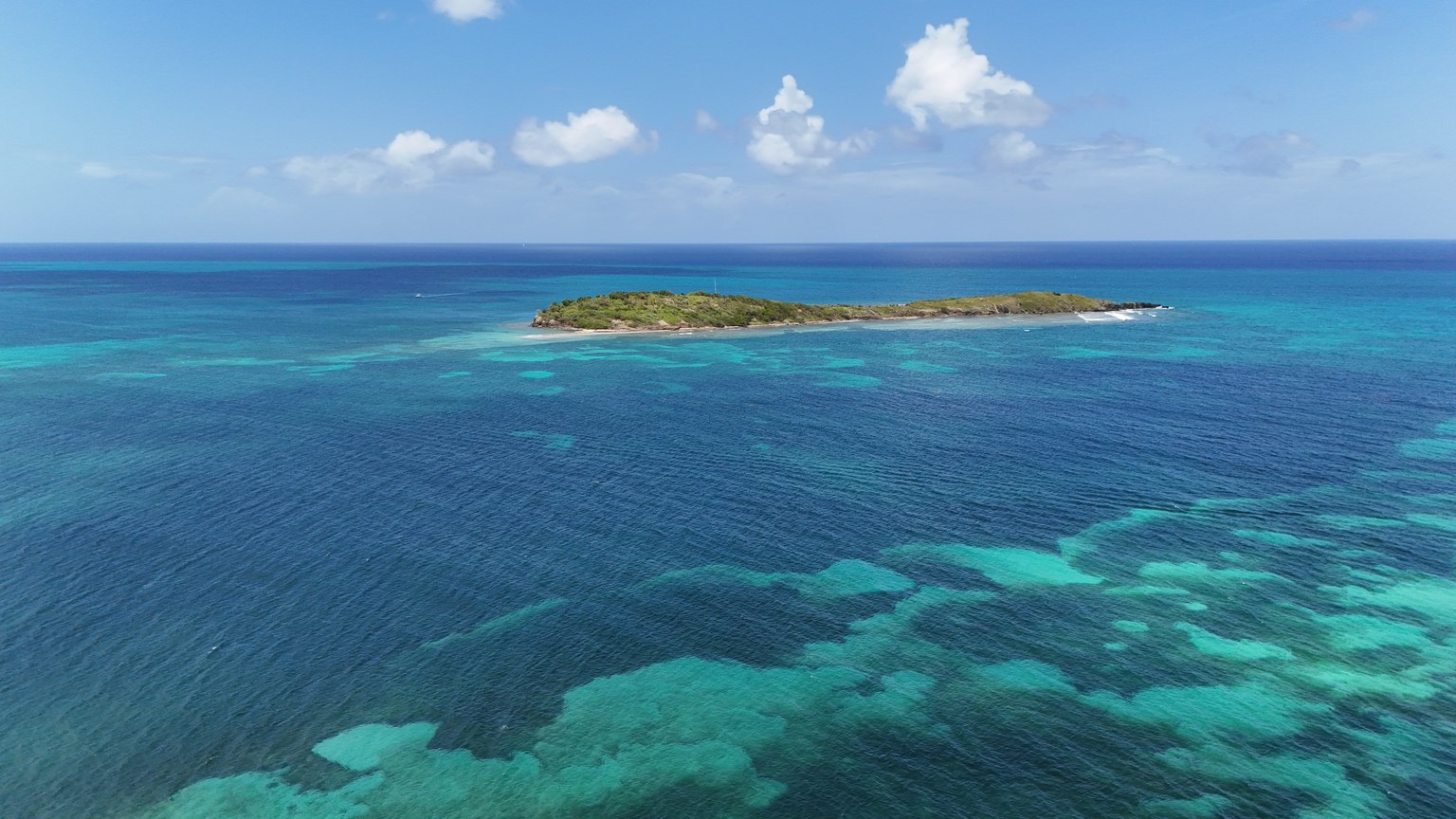 Stunning aerial view of a tropical island surrounded by clear blue waters in St. Croix, U.S. Virgin Islands.