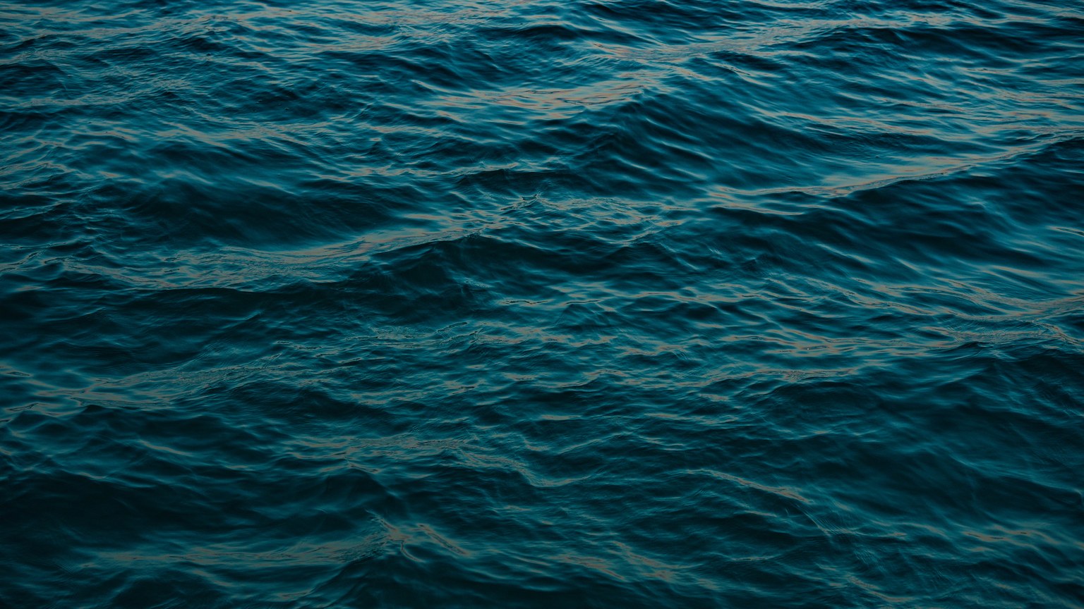 A peaceful view of ocean waves with rich blue hues, capturing the sea's tranquility.