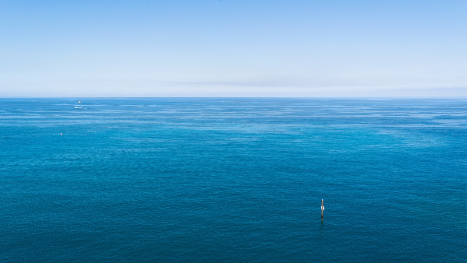 A tranquil aerial view of the Caribbean Sea showcasing its calm and vivid blue waters.