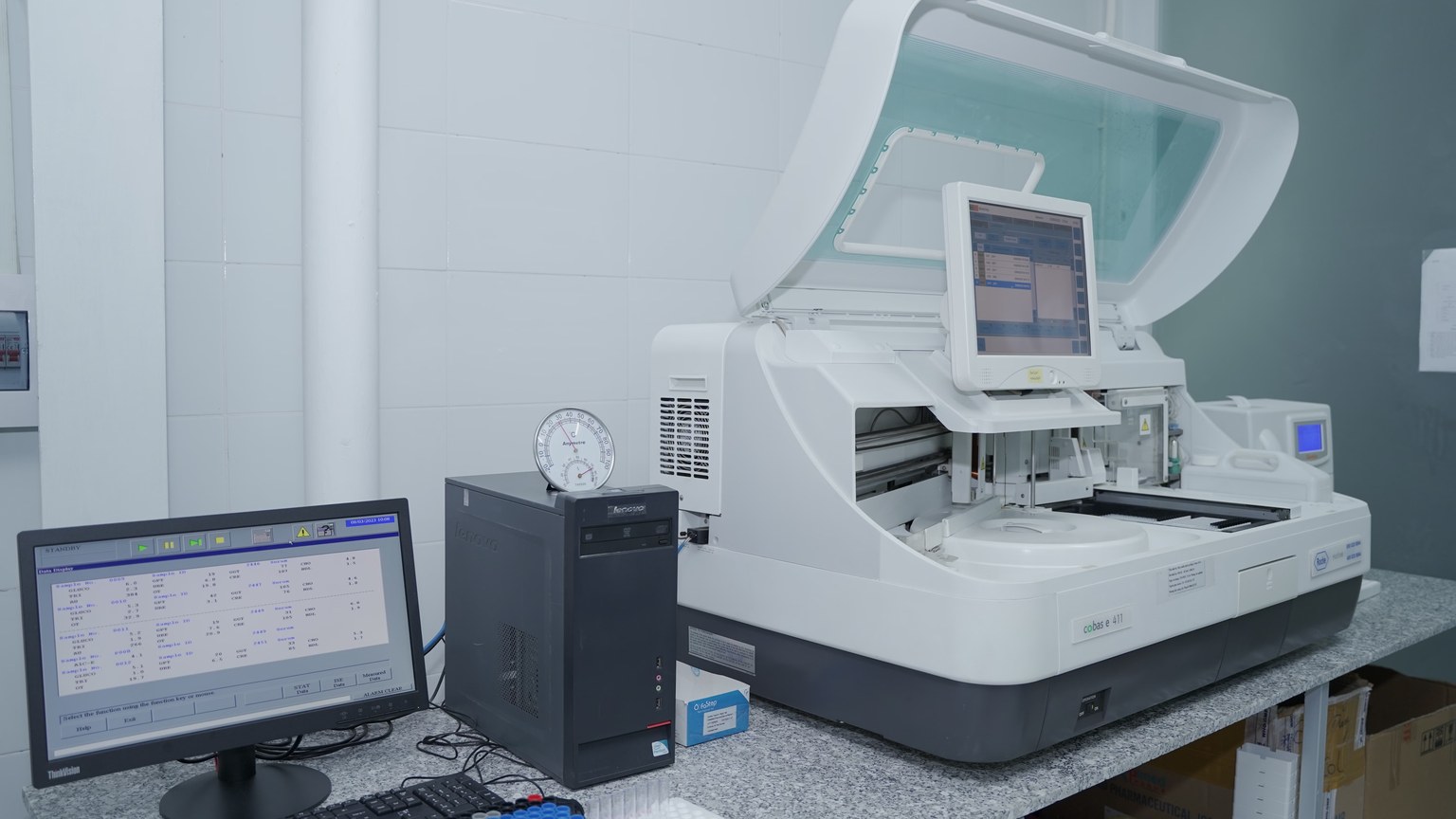 High-tech laboratory equipment with computer system in lab setting.