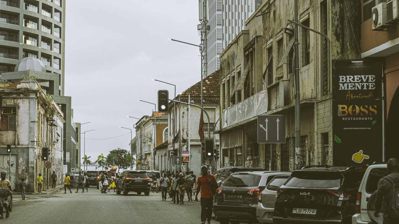 Bustling street scene in downtown Luanda, Angola with historic and modern buildings.