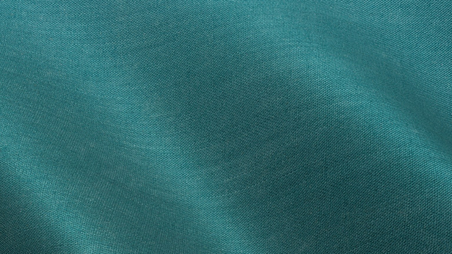 Close-up of a teal-colored fabric texture with gentle waves and folds.