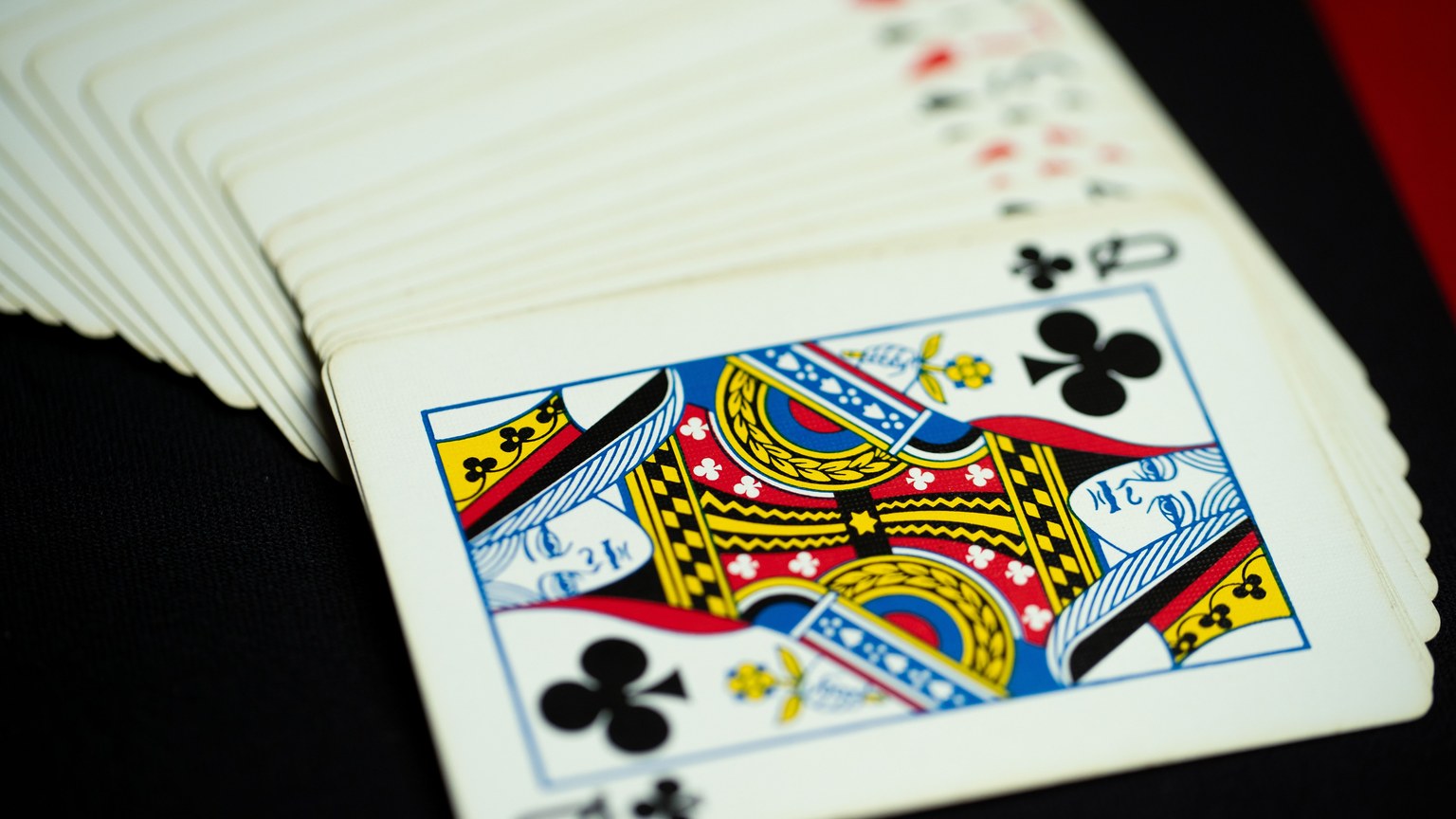 Detailed shot of a King of Clubs card from a classic deck of playing cards, stylishly fanned out.
