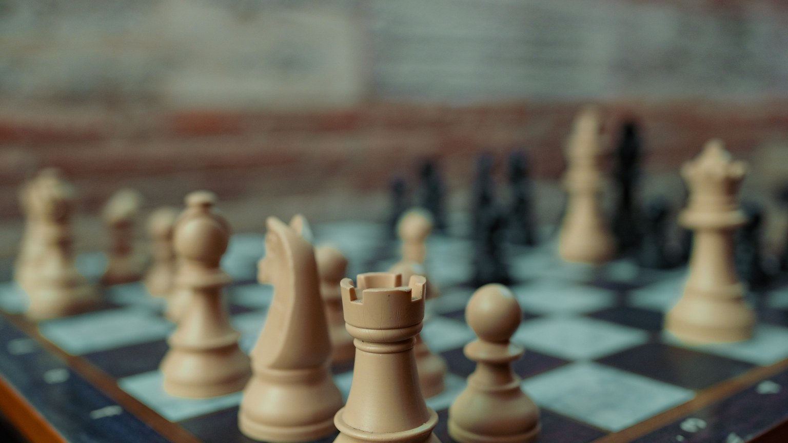 Close-up view of chess pieces on a board showcasing a game in progress, emphasizing strategy and intellect.