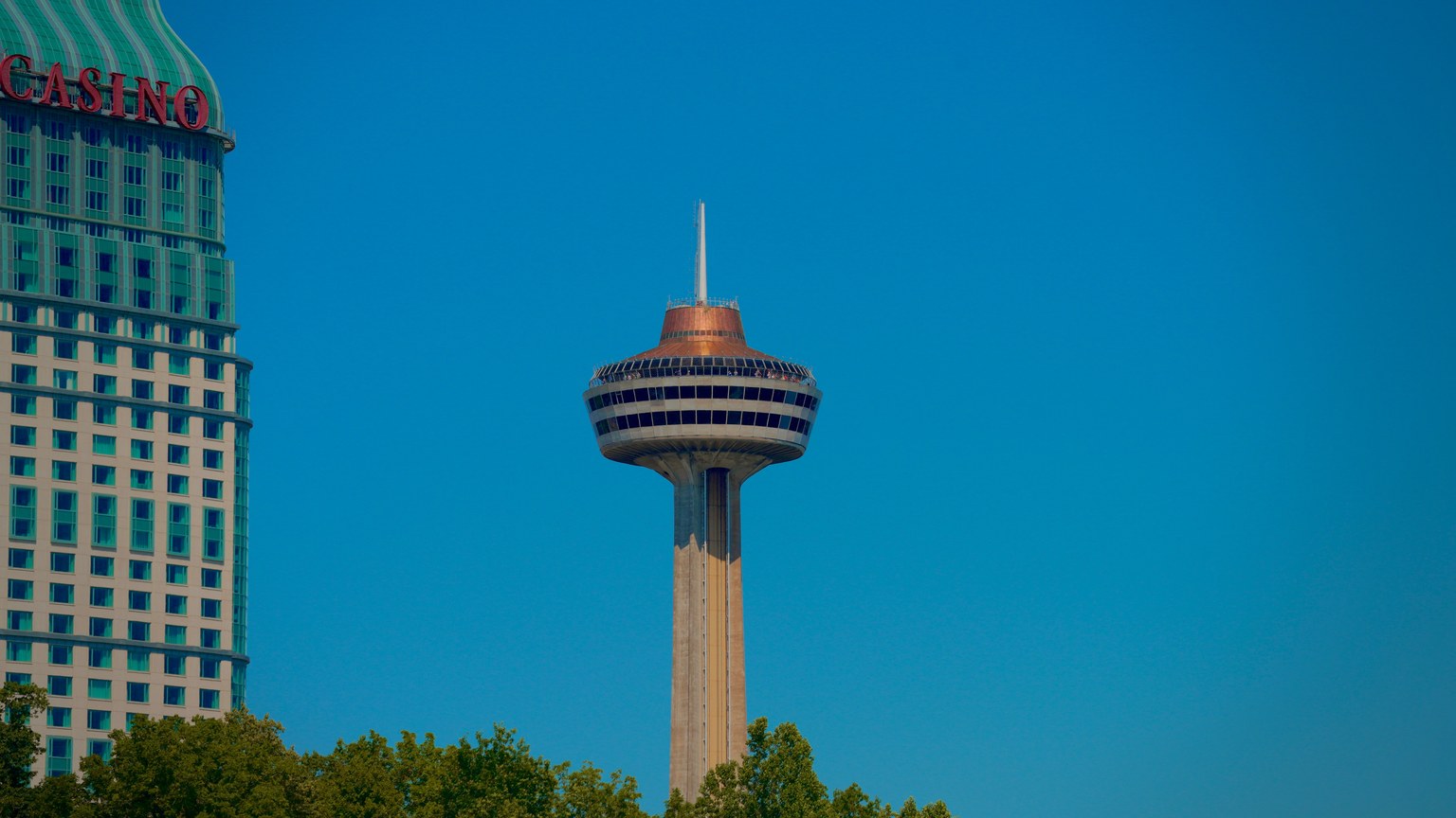 View of the Skylon Tower and casino against a clear blue sky in Niagara Falls, Ontario.