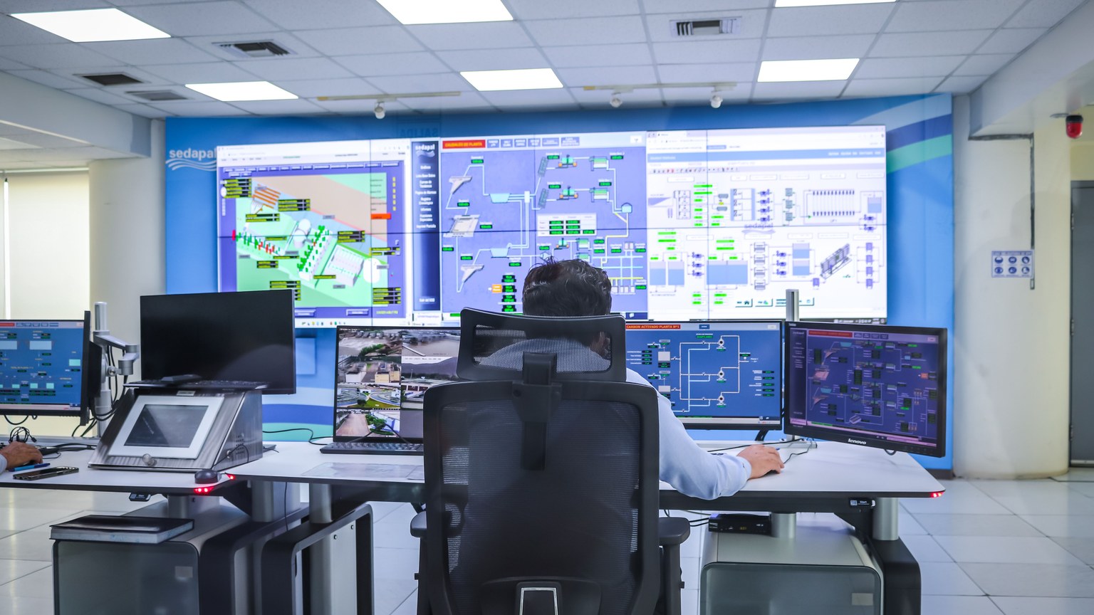 Operator in a modern control room managing technological systems in El Agustino, Lima.